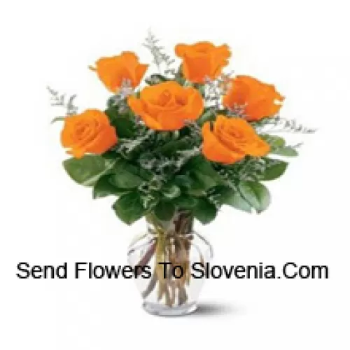 7 Yellow Roses With Some Ferns In A Glass Vase