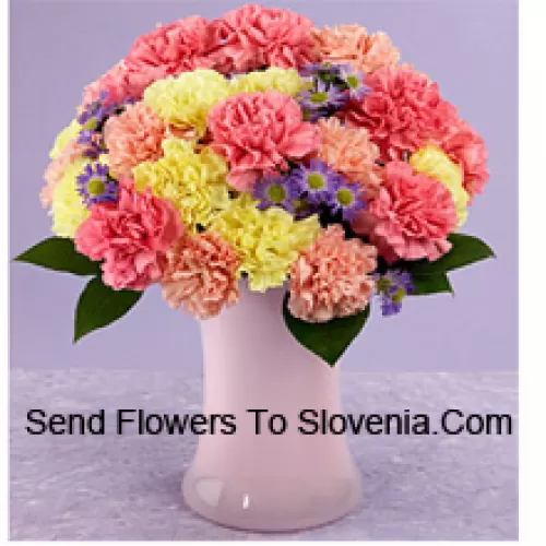 25 Mixed Colored Carnations With Seasonal Fillers In A Glass Vase