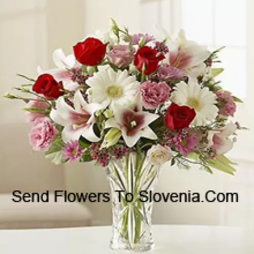 Red Roses, Pink Carnations White Gerberas And White Lilies With Other Assorted Flowers In A Glass Vase