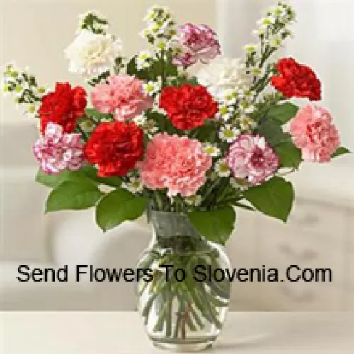 11 Mixed Colored Carnations With Some Ferns In A Glass Vase