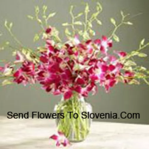 Orchids With Seasonal Fillers In A Vase