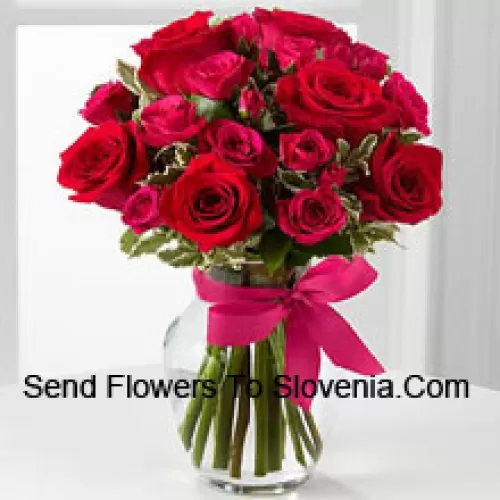 19 Red Roses With Seasonal Fillers In A Glass Vase Decorated With A Pink Bow