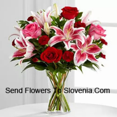 Red And Pink Roses With Pink Lilies And Seasonal Fillers In A Glass Vase