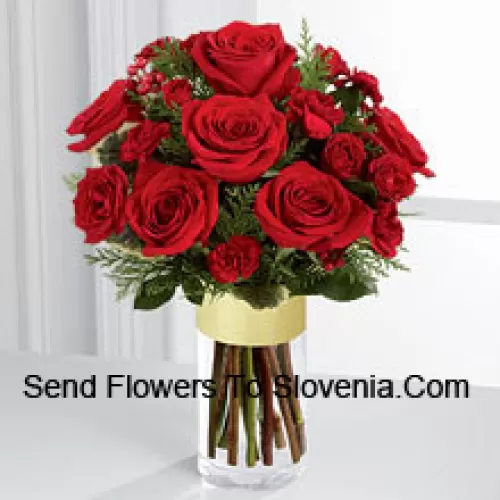 Send them the warmth and heartfelt sentiments expressed throughout the holiday season. Rich red roses and spray roses are offset by burgundy mini carnations, variegated holly stems and assorted holiday greens, beautifully arranged in a clear glass gold banded vase to bring your special recipient a merry moment they will treasure throughout the Christmas season. (Please Note That We Reserve The Right To Substitute Any Product With A Suitable Product Of Equal Value In Case Of Non-Availability Of A Certain Product)