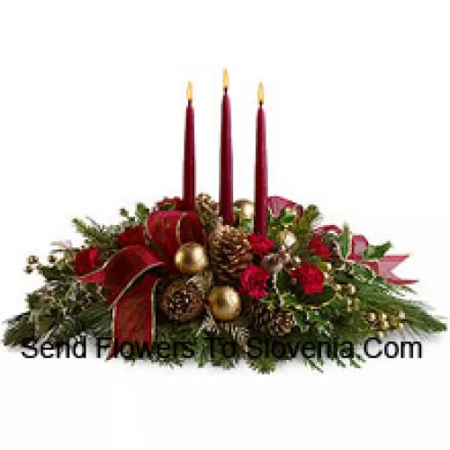 Red miniature carnations, pinecones, golden ornament balls, faux berries and assorted fresh evergreens? accented with a wired ribbon are arranged in a?low dish?with three red taper candles. (Please Note That We Reserve The Right To Substitute Any Product With A Suitable Product Of Equal Value In Case Of Non-Availability Of A Certain Product)